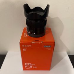 Sony 35mm f/1.8 OSS lens, with hood and box