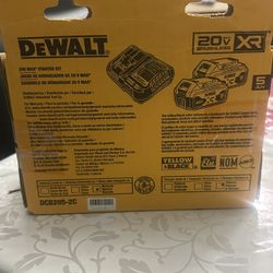 Two Walt batteries with their charger
