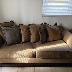 Brown love seat and sofa