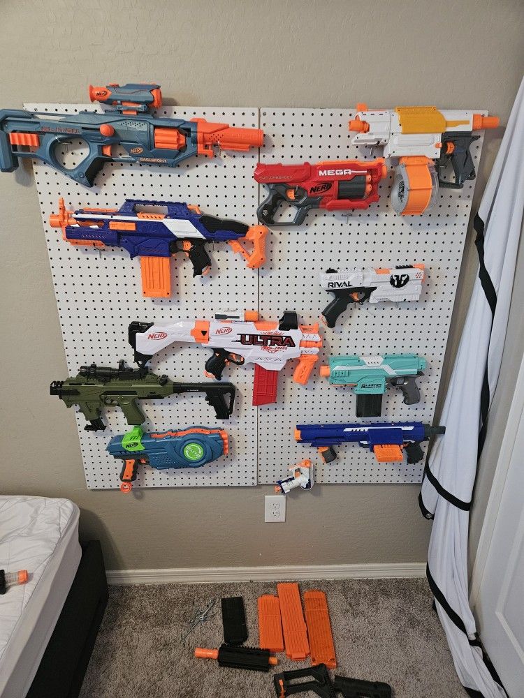 12 NERF, pegboard, and extra clips and pegs