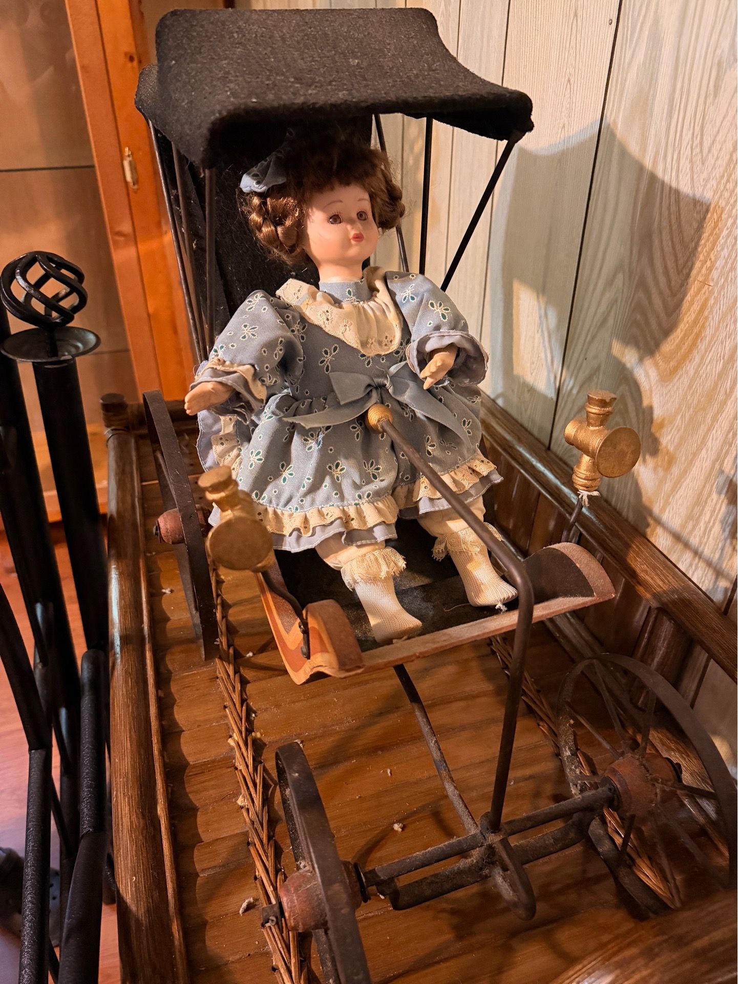 Porcelain Doll in Vintage Buggy