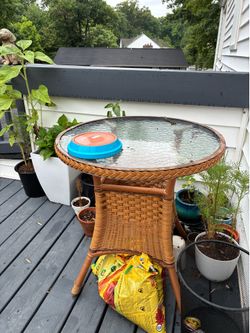 Outdoor wicker and glass coffee table