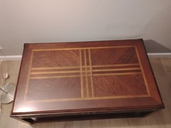Wooden coffee table beautiful design on the top.