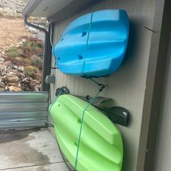 Two lifetime kayaks with kayak dollies and paddles
