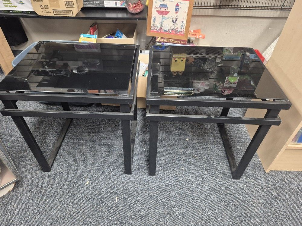 set of black glass coffee and end tables with metal frames. 