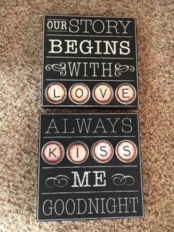 2 wood wall hanging slightly one says Always kiss me goodnight and the other one says our story begins with love!