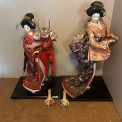 A Pair Of Oriental Dolls With Two Small Vases From Japan
