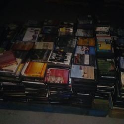 Pallet of DVDs, CDs, and VHS tapes