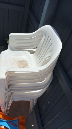 9 White plastic chairs