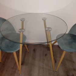 Beautiful glass table and blue velvet chairs