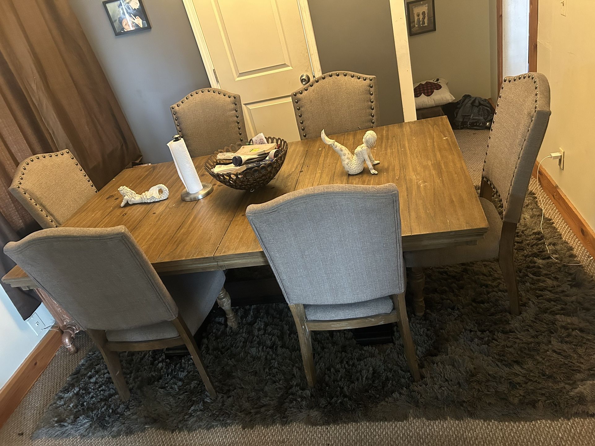 Natural wood table, 6 chairs and rug and table ornaments