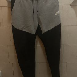 Black and Grey nike tech pants