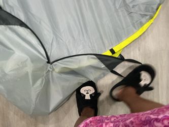 A grey and yellow pop-up tent or privacy shelter (new)