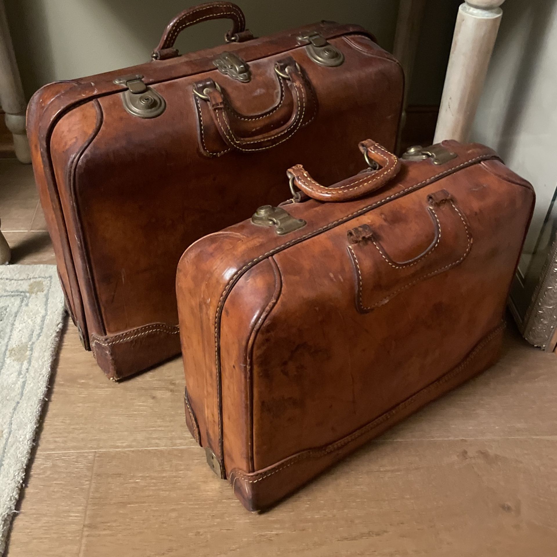 Vintage antique matching pair of leather suitcases luggage