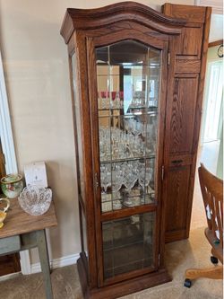 wooden curio china cabinet with mirrored back and glass shelves