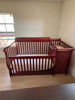 Brownish red convertible crib
