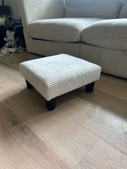 Upholstered footstool for couch
