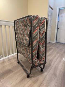 Folding bed with mattress