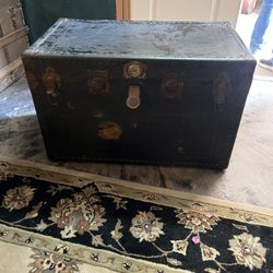 Antique steamer trunk with metal reinforcements and hardware.