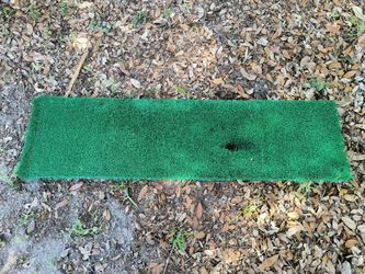 Golf simulator strike plate with pre-drilled hole for rubber tees