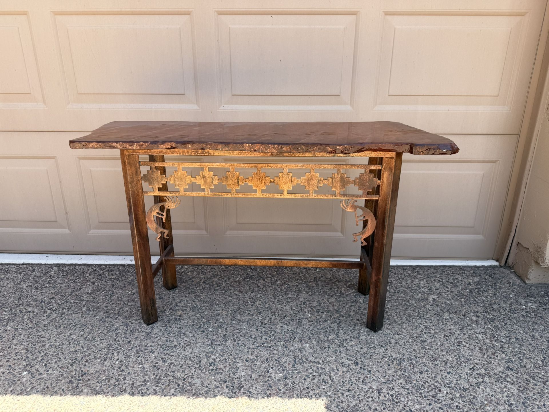 Stone topped entry table on top of metal base