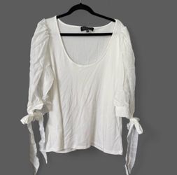 Soft draped cowl neckline for a feminine touch. Smooth, lightweight fabric with long sleeves. Classic navy shade for easy pairing. Clean, modern silho