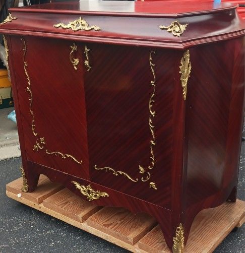 Antique phonograph housed within a decorative wooden cabinet, likely from the early 20th century