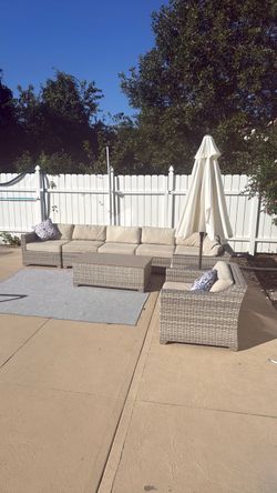 Patio set (8 pieces) with 2 outdoor pillows, outdoor, blue and white Area Rug, white umbrella and black umbrella base.
