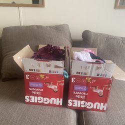 2 boxes of baby girl clothes and 11 unused bottles