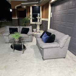 Beautiful two piece grey sofa set with glass table included asking 580 in great condition comfy and clean 