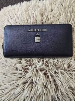 The Michael Kors Adele Midnight Leather Zip Around Continental Wallet is a stylish and functional accessory for women. Made from luxurious leather wit