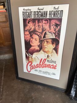 Beautiful framed print of the iconic Casablanca movie poster featuring Humphrey Bogart and Ingrid Bergman. A timeless piece perfect for movie lovers, 