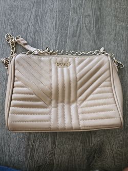 Guess convertible crossbody bag with a gold chain strap.