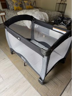 Like new Graco Pack & Player w / Millard double sided mattress.  Plus six soft jersey sheets