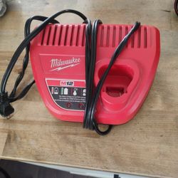 Milwaukee Battery Charger And Two M12 Batterys