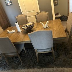 Natural wood table, 6 chairs and rug and table ornaments