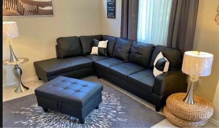 Black leather sectional couch and ottoman