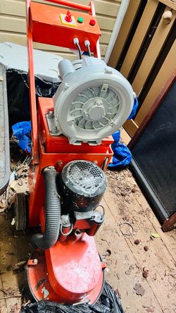 heavy-duty walk-behind concrete floor grinder/polisher with an integrated dust-collection system
