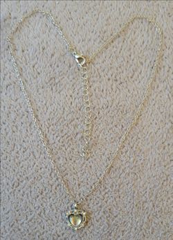Silver chain with a heart-shaped pendant featuring a reflective stone.