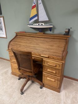 Antique solid oak roll-top desk paired with a Bentwood cane-back swivel chair