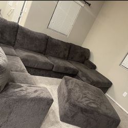 Gray sectional couch with ottoman