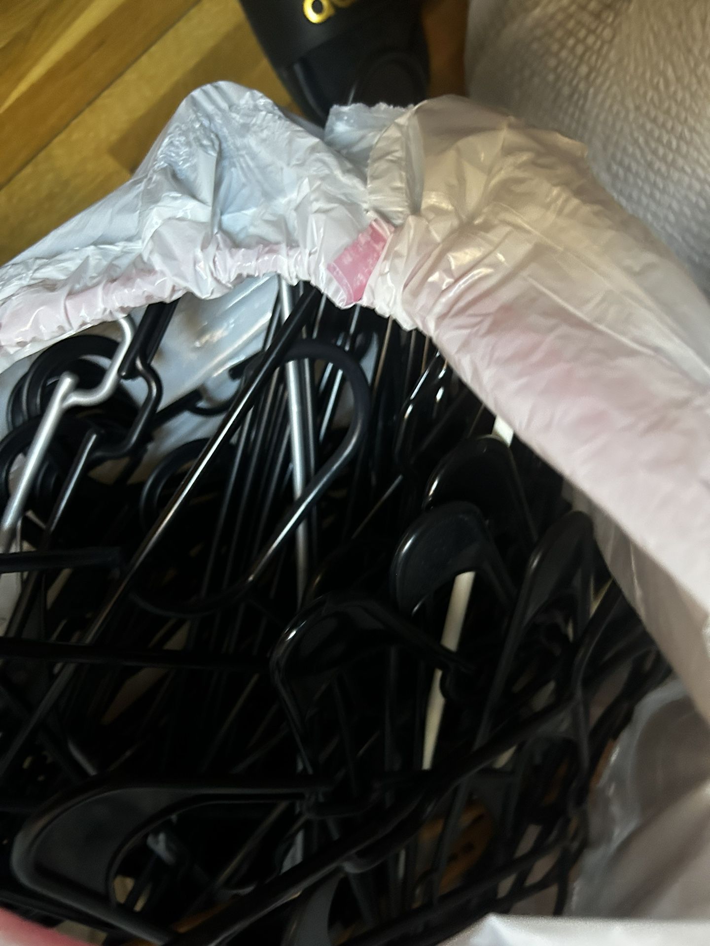 big bag of black plastic hangers