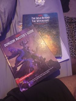 D&D Dungeon Masters Guide And The Wild Beyond The Witchlight Adventure Guide. 