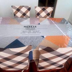 Dining table and four chairs with two covers