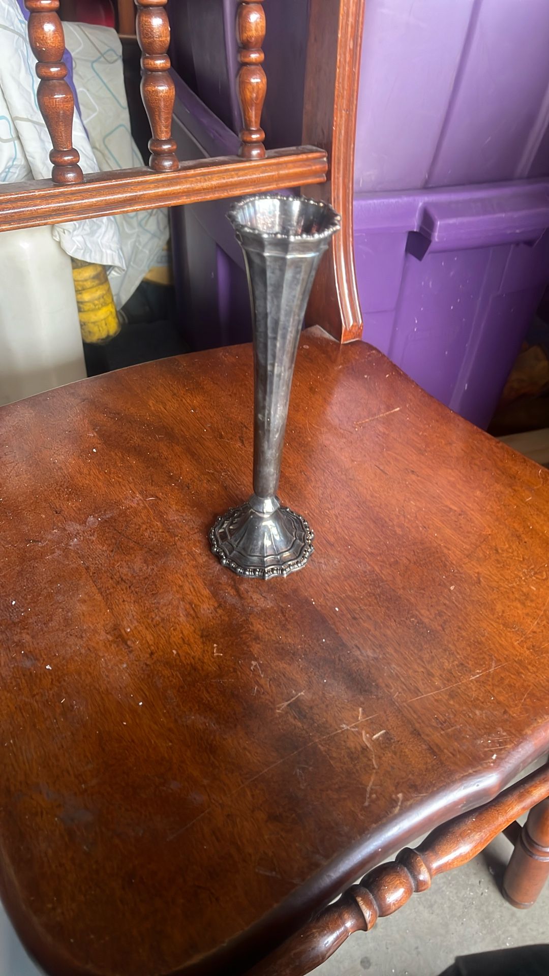 This is a vintage silver-plated trumpet vase.