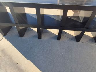black wooden storage console with open shelving.