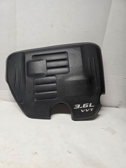 Mopar 3.6L V6 VVT engine cover is an OEM replacement part designed for 11-23 Dodge Charger, Challenger, and Chrysler 300 models equipped with the Pent