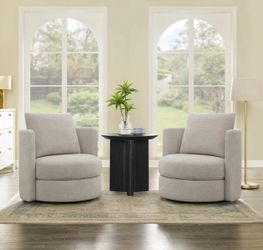 chairs come as a set of two and feature a sculptural barrel-back design upholstered in a neutral gray polyester fabric. Each chair is built on a solid