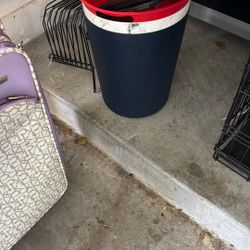 Bathroom, trash cans, one white and black the other blue
