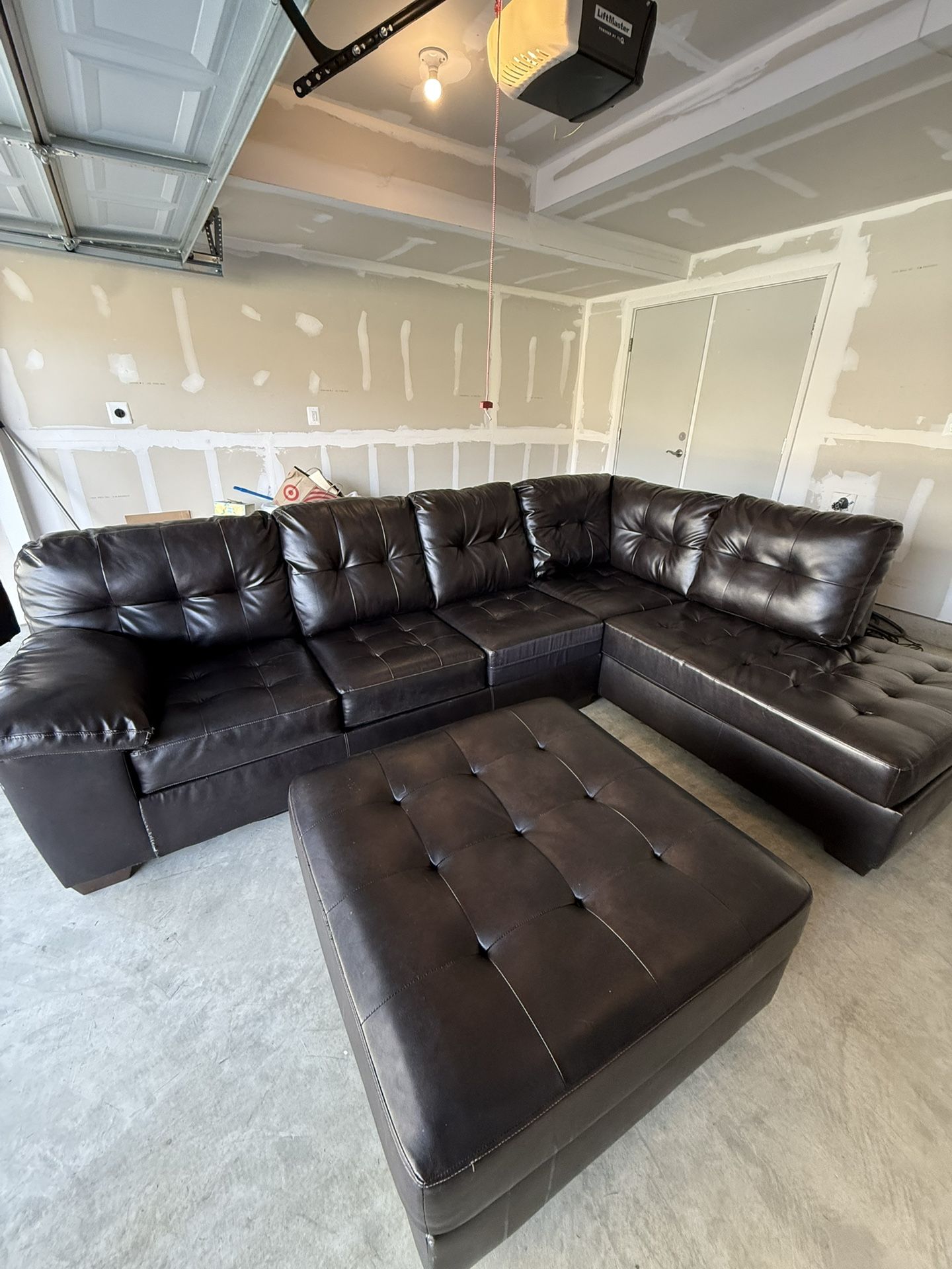 Black leather sectional With Ottoman